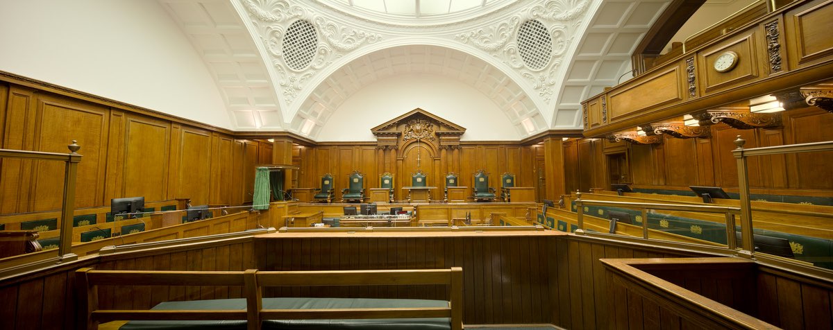 An empty hearing room with wood panelling